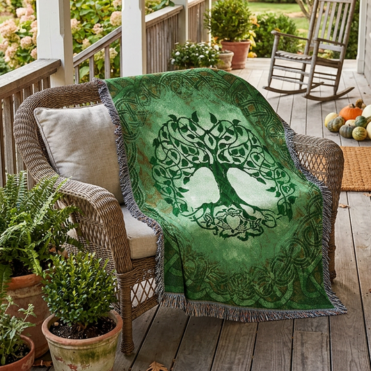A square woven throw blanket featuring a Celtic-style tree of life design in shades of green, with a central tree motif, ornate border patterns, and fringed edges.