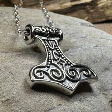 Load image into Gallery viewer, Silver Mjällnir pendant on a chain against a stone background