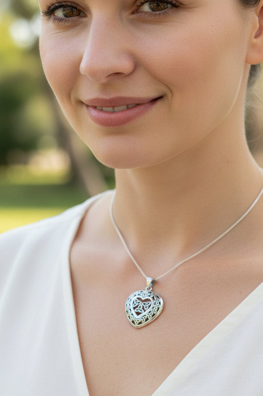 a woman wearing a celtic heart pendant in sterling silver