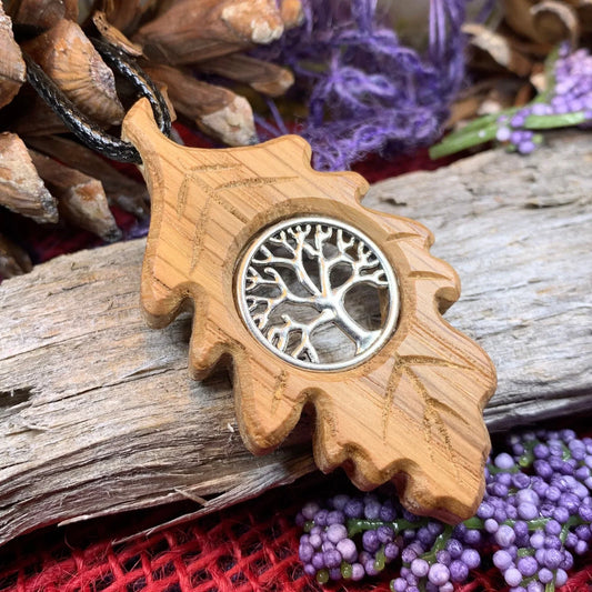 A wooden oak-leaf pendant with a sterling silver Celtic Tree of Life