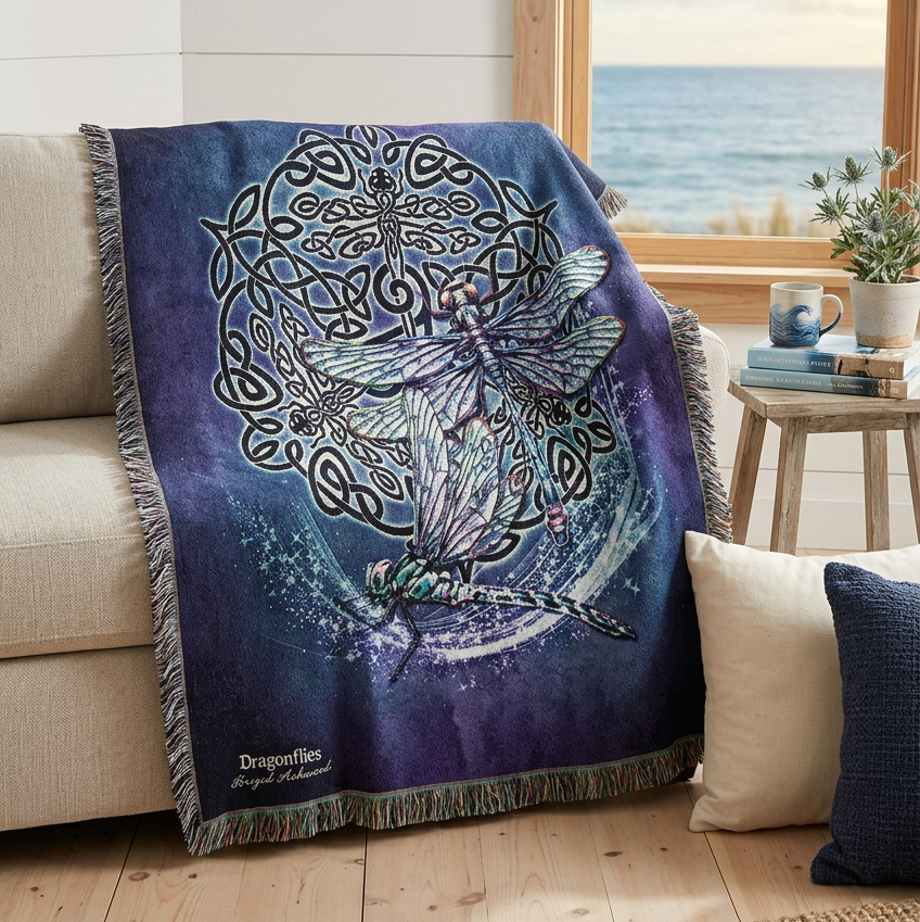 A woven throw blanket featuring a detailed fantasy design of two dragonflies surrounded by Celtic knotwork and a tree motif on a dark purple background, finished with fringed edges.