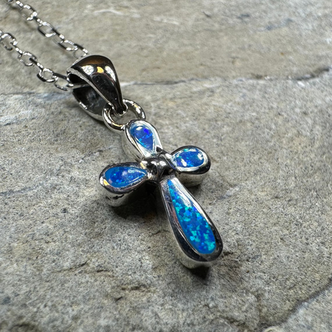 Load image into Gallery viewer, Opal cross necklace on a stone surface
