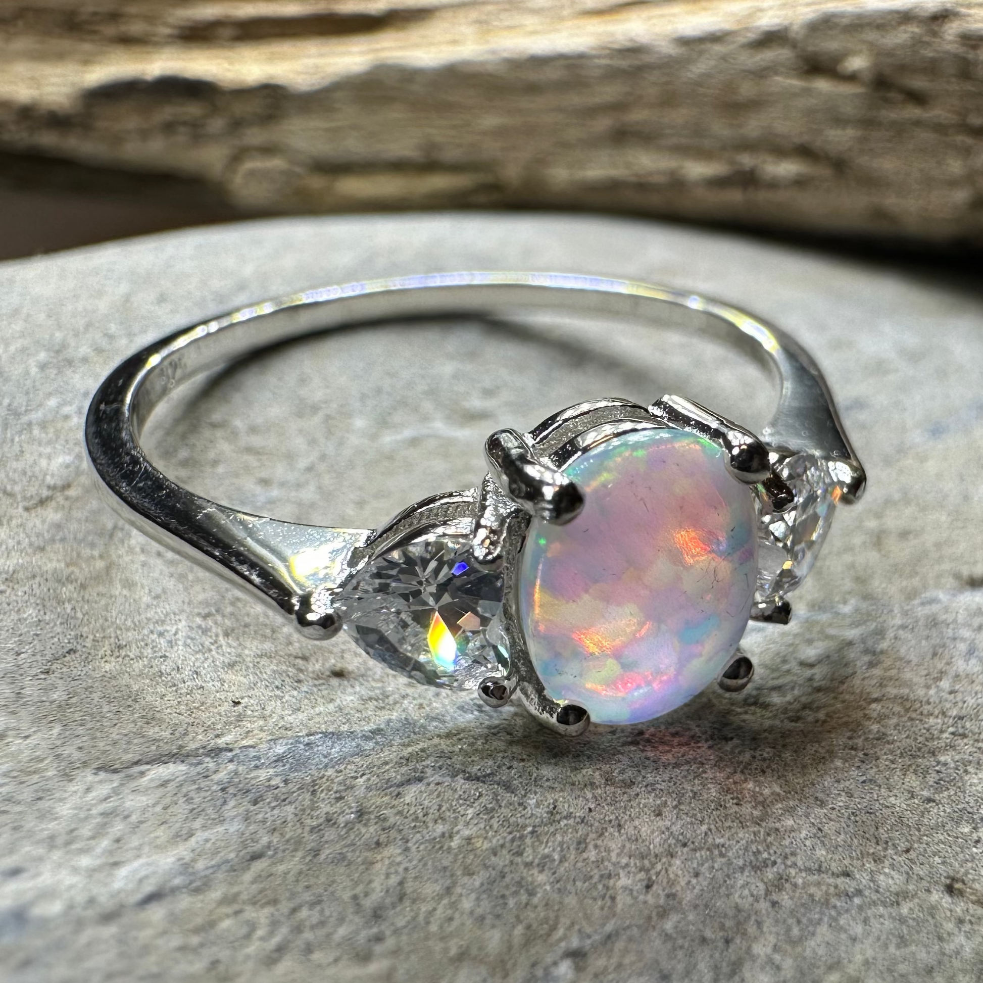 Opal ring on a stone surface with a natural background